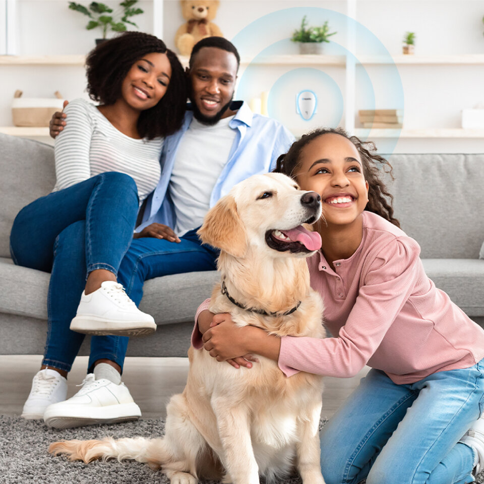 Family relaxing at home with a Repellio device plugged in